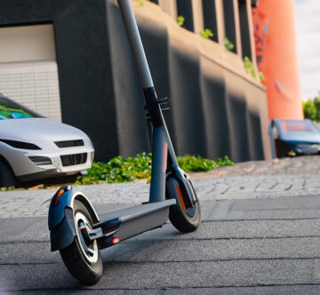 Firefly electric scooter with a street and wind